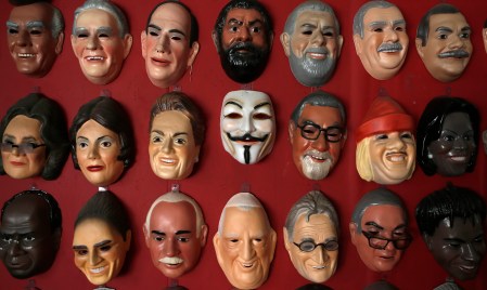Guy Fawkes mask hangs on wall at a factory in Sao Goncalo
